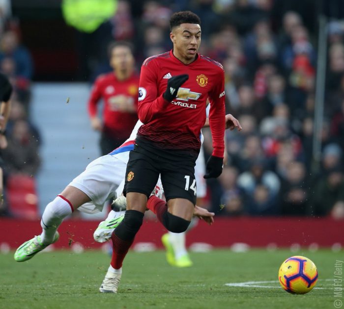 Manchester United's striker, Lingard, dribbles past a Crystal Palace player. Manchester United drew 0-0 with the visitors at Old trafford