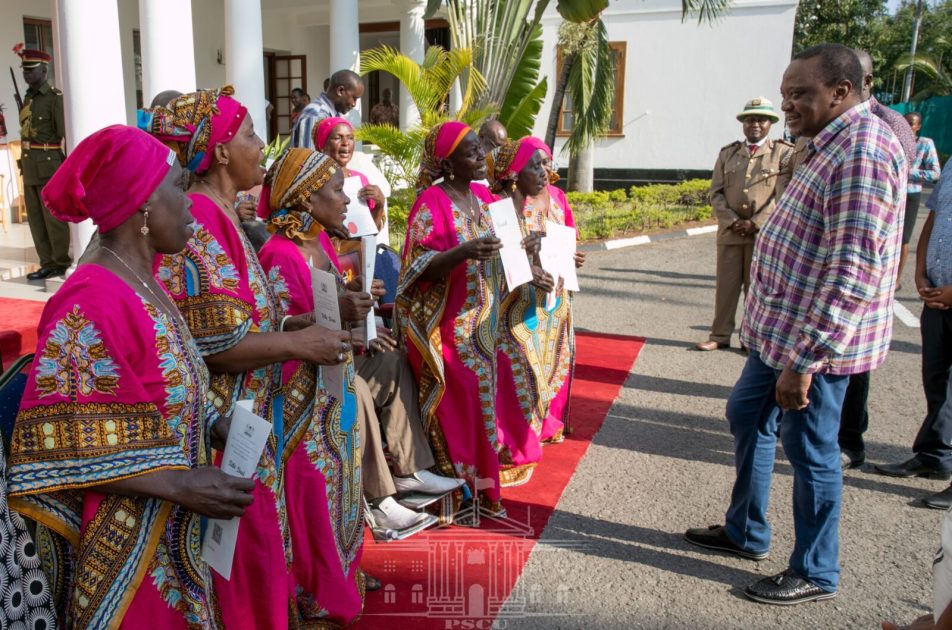 President Uhuru Kenyatta, right, has met and rewarded members of the legendary Mwakigwena Choir Group from Gombatu in Kwale. As part of the government's reward, each of the 14 members of the group has been allocated 3 acres of land at the Bunguni Settlement Scheme in Kwale County.