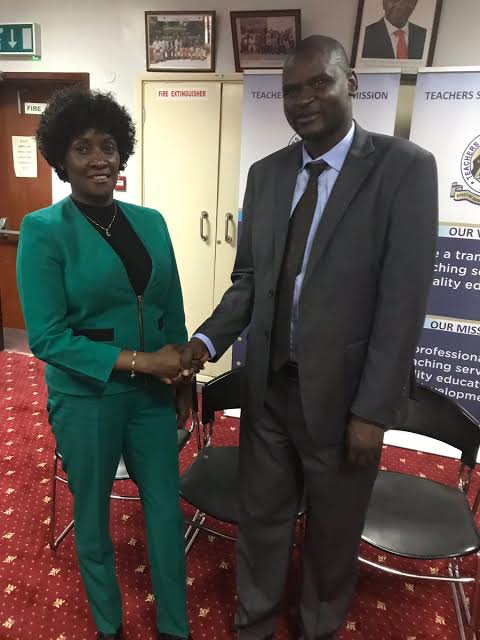 Mr. Eric Ademba, right, winner of the 2019 edition of the African Union Continental Teacher Award is congratulated by the TSC boss, Dr. Nancy Macharia. Photo/ File.