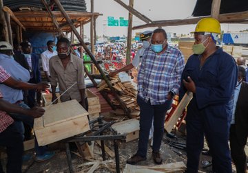 President Uhuru Kenyatta, left, launches the free school desks programme.