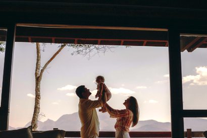 A father and mother cuddling their baby.